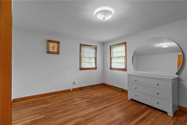 11 Cedar Ave, Middletown, RI 02842 - unfurnished bedroom with light wood finished floors, baseboards, and baseboard heating