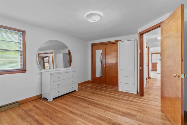 11 Cedar Ave, Middletown, RI 02842 - unfurnished bedroom with light wood-style floors, baseboards, and a baseboard heating unit
