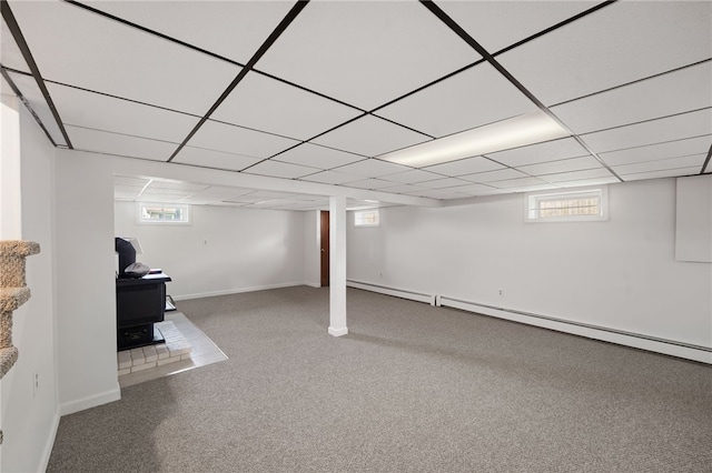 204 Robert Gray Ave, Tiverton, RI 02878 - basement featuring a wood stove, carpet floors, baseboards, and a baseboard heating unit