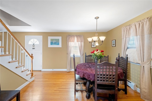 204 Robert Gray Ave, Tiverton, RI 02878 - dining space featuring a chandelier, light wood-type flooring, stairs, and baseboards