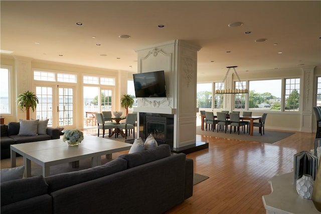 38 Bay St Unit W201/202, Westerly, RI 02891 - living area featuring wood finished floors, crown molding, a premium fireplace, and recessed lighting