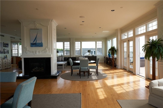 38 Bay St Unit W201/202, Westerly, RI 02891 - dining room with light wood finished floors, a fireplace, and ornamental molding