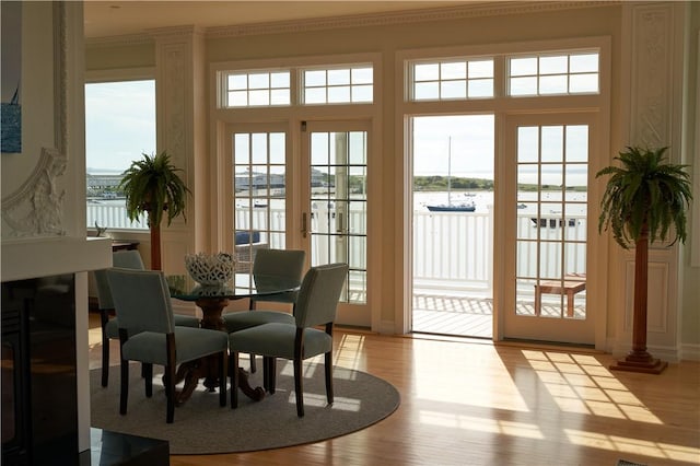 38 Bay St Unit W201/202, Westerly, RI 02891 - doorway to outside with a water view, healthy amount of natural light, and light wood finished floors