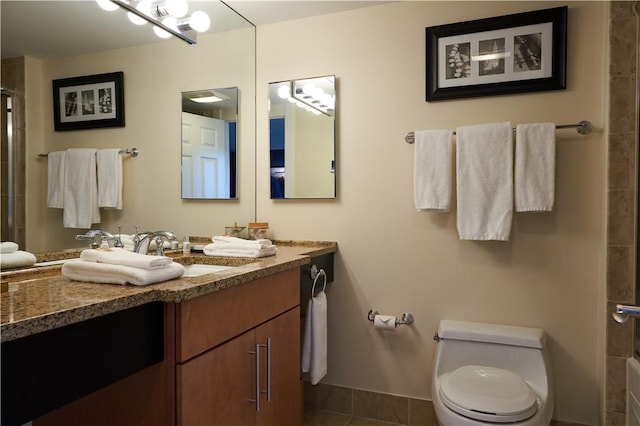 38 Bay St Unit W201/202, Westerly, RI 02891 - bathroom featuring a shower with door, vanity, toilet, and tile patterned flooring