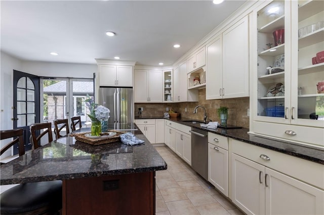 136 White Birch Cir, Scituate, RI 02831 - kitchen featuring stainless steel appliances, a sink, a kitchen breakfast bar, decorative backsplash, and light tile patterned floors