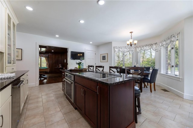136 White Birch Cir, Scituate, RI 02831 - kitchen featuring a chandelier, appliances with stainless steel finishes, a breakfast bar, dark stone counters, and baseboards