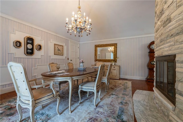 136 White Birch Cir, Scituate, RI 02831 - dining space featuring a fireplace, a chandelier, crown molding, baseboards, and a wainscoted wall