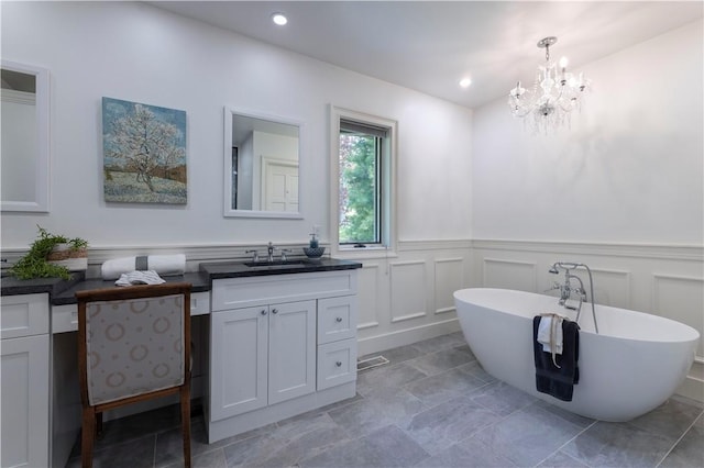 136 White Birch Cir, Scituate, RI 02831 - full bath with vanity, a wainscoted wall, a soaking tub, a chandelier, and a decorative wall