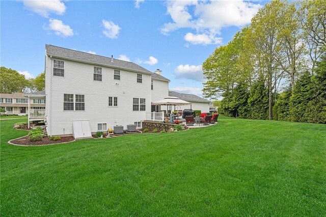 14 Ginger Trl, Coventry, RI 02816 - back of house featuring a gazebo, central air condition unit, a yard, and a chimney