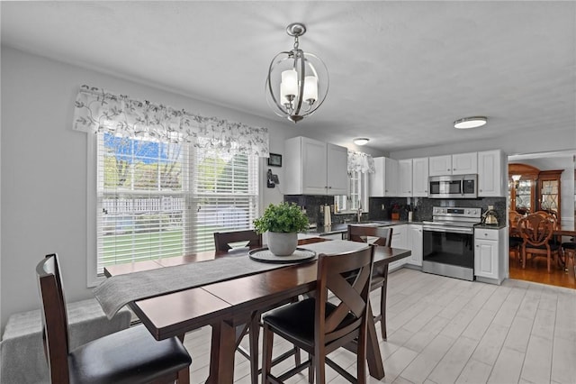 14 Ginger Trl, Coventry, RI 02816 - dining area with plenty of natural light, a chandelier, and light wood-type flooring