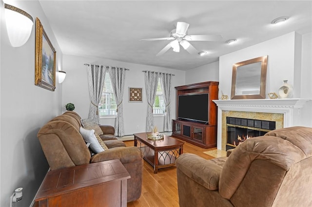 14 Ginger Trl, Coventry, RI 02816 - living area featuring light wood-style floors, a high end fireplace, ceiling fan, and a baseboard heating unit