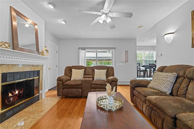 14 Ginger Trl, Coventry, RI 02816 - living room with baseboard heating, wood finished floors, a premium fireplace, and ceiling fan
