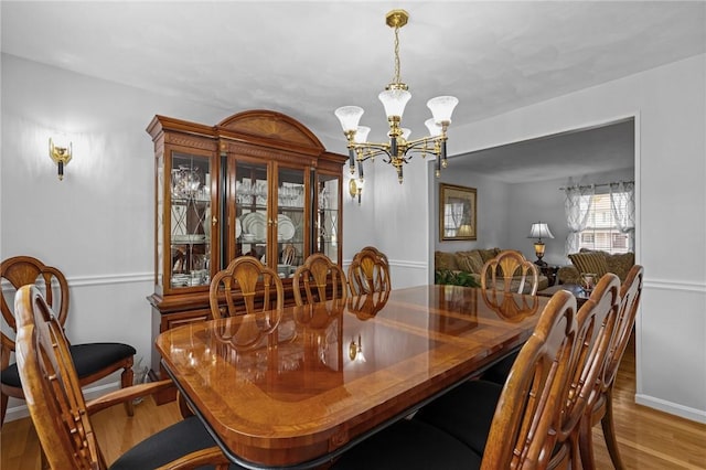 14 Ginger Trl, Coventry, RI 02816 - dining space featuring a chandelier, wood finished floors, and baseboards