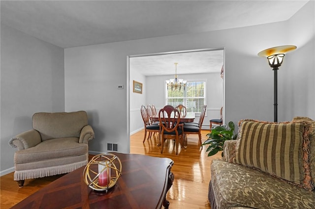 14 Ginger Trl, Coventry, RI 02816 - living area with a chandelier and light wood-style floors
