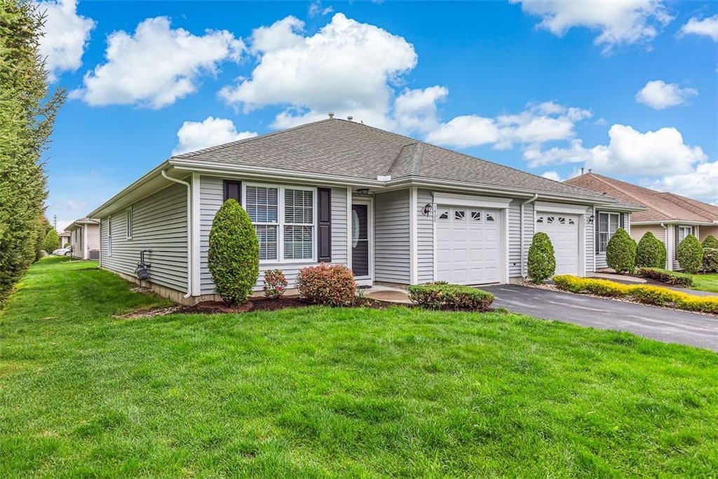 1404 Village Green Cir, Coventry, RI 02816 - ranch-style home featuring a garage, asphalt driveway, and a front yard