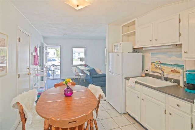 88 Old Post Rd Unit 10, Westerly, RI 02891 - kitchen with a sink, white appliances, white cabinetry, light tile patterned floors, and open floor plan