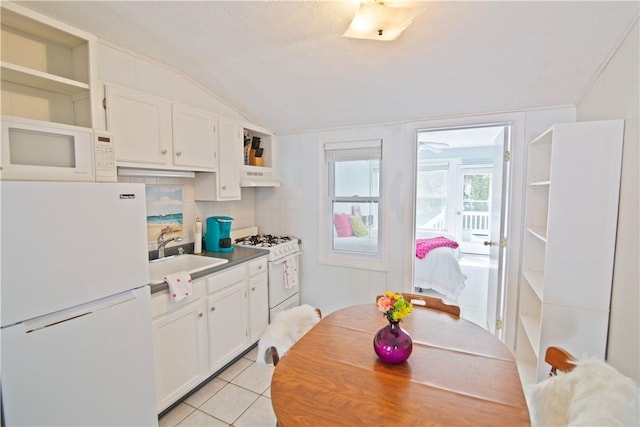 88 Old Post Rd Unit 10, Westerly, RI 02891 - kitchen with white appliances, open shelves, a sink, under cabinet range hood, and white cabinetry