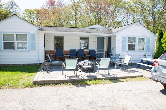 88 Old Post Rd Unit 10, Westerly, RI 02891 - back of property with a patio, roof with shingles, and a fire pit