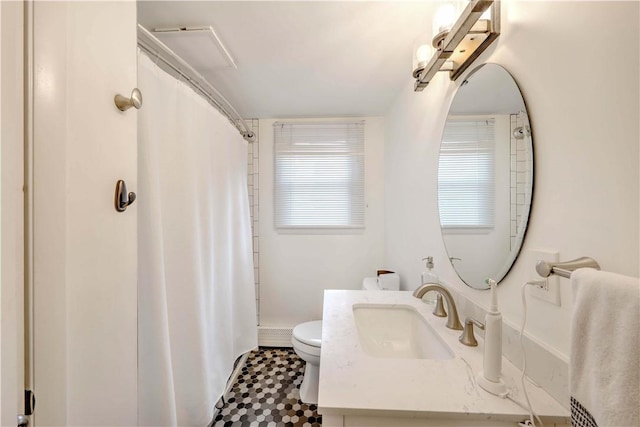 bathroom featuring toilet, vanity, curtained shower, baseboards, and tile patterned floors
