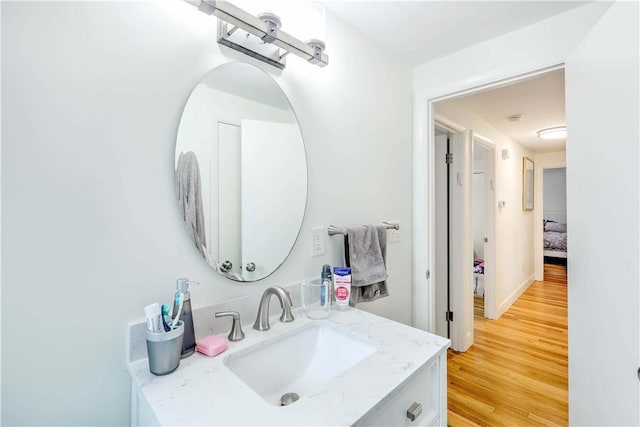 bathroom featuring wood finished floors and vanity