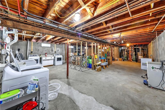 unfinished basement with independent washer and dryer and water heater