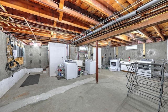unfinished below grade area featuring separate washer and dryer and a sink