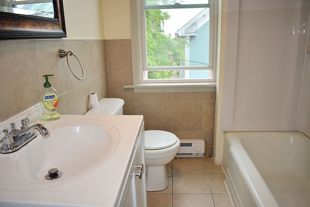 bathroom featuring a baseboard radiator, toilet, tile walls, tile patterned floors, and a bathtub