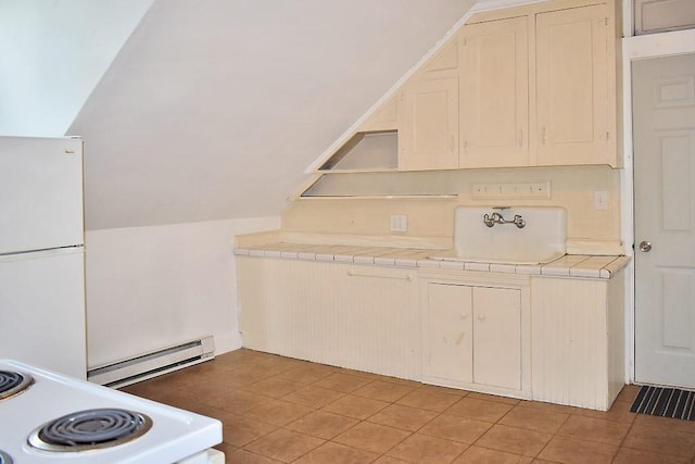 kitchen with white appliances, baseboard heating, tile counters, and a sink