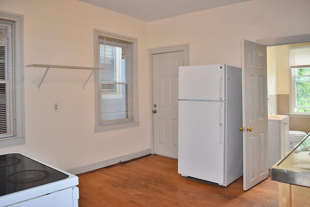 kitchen with white appliances and light wood-type flooring