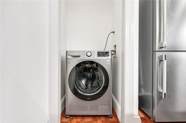 laundry room featuring washer / dryer and wood finished floors