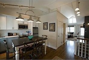 44 Bay St Unit B105/B205, Westerly, RI 02891 - dining room featuring lofted ceiling, dark wood finished floors, and baseboards