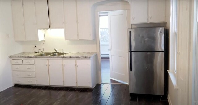243 Transit St, Woonsocket, RI 02895 - kitchen featuring freestanding refrigerator, a sink, light countertops, and white cabinets