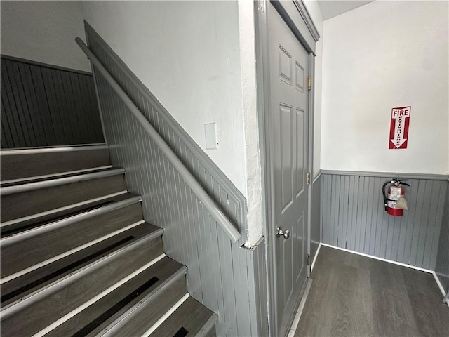 243 Transit St, Woonsocket, RI 02895 - stairway with wainscoting and wood finished floors
