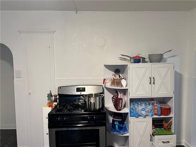 243 Transit St, Woonsocket, RI 02895 - kitchen featuring stainless steel gas stove, open shelves, and white cabinetry