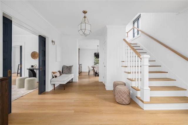 104 Second St, Newport, RI 02840 - entrance foyer featuring light wood-style flooring, stairway, ornamental molding, and baseboards
