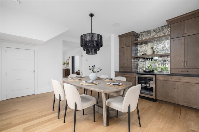 104 Second St, Newport, RI 02840 - dining space featuring beverage cooler, a chandelier, light wood finished floors, and bar area