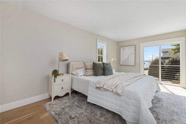 104 Second St, Newport, RI 02840 - bedroom featuring access to exterior, multiple windows, baseboards, and wood finished floors