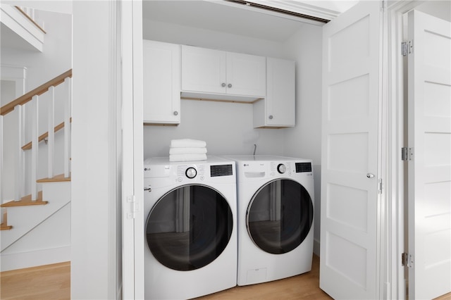 104 Second St, Newport, RI 02840 - washroom featuring washing machine and dryer, light wood-style floors, and cabinet space