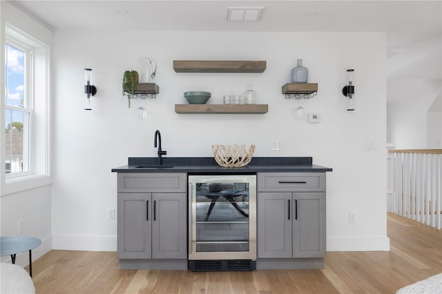 104 Second St, Newport, RI 02840 - indoor wet bar featuring beverage cooler, light wood finished floors, and baseboards