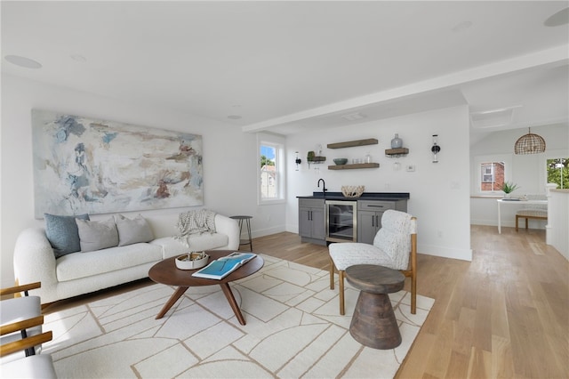 104 Second St, Newport, RI 02840 - living area with beverage cooler, bar with sink, plenty of natural light, and light wood-style flooring