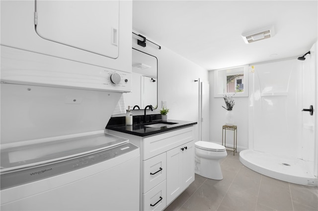 104 Second St, Newport, RI 02840 - bathroom featuring stacked washer and clothes dryer, toilet, vanity, and walk in shower