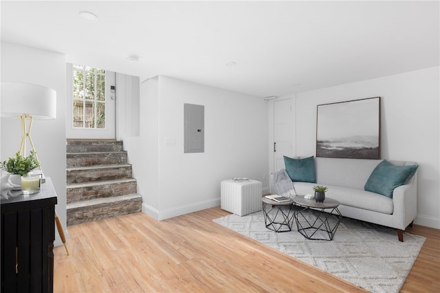 104 Second St, Newport, RI 02840 - living room with electric panel, wood finished floors, baseboards, stairway, and radiator
