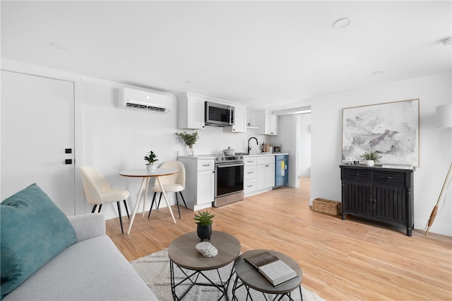 104 Second St, Newport, RI 02840 - living room with a wall unit AC, light wood-style flooring, and baseboards