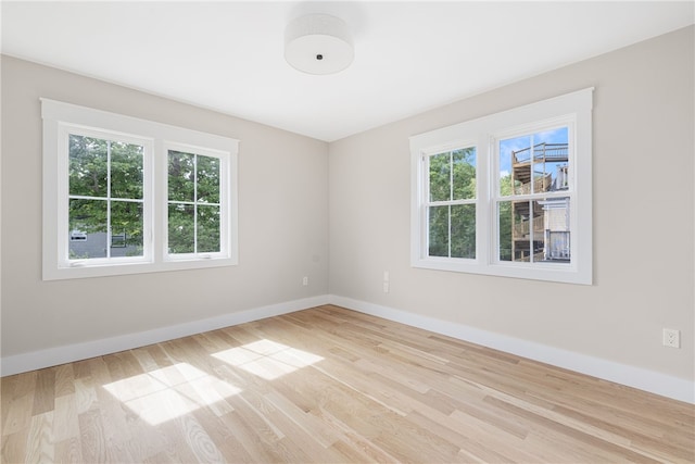 104 Second St, Newport, RI 02840 - spare room with healthy amount of natural light, wood finished floors, and baseboards