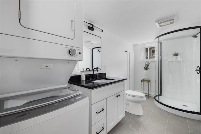 104 Second St, Newport, RI 02840 - bathroom featuring stacked washer and clothes dryer, toilet, a stall shower, and vanity