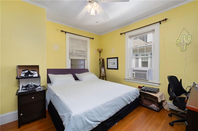 178 Gould Ave, Warwick, RI 02888 - bedroom featuring cooling unit, hardwood / wood-style floors, a baseboard radiator, crown molding, and a ceiling fan