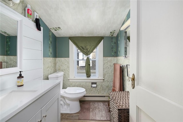 178 Gould Ave, Warwick, RI 02888 - full bathroom with baseboard heating, toilet, wood finished floors, vanity, and tile walls
