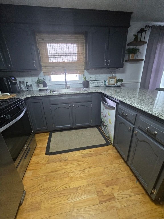 59 Columbus Ave, North Providence, RI 02911 - kitchen with stainless steel appliances, a sink, light wood-style floors, and light stone counters