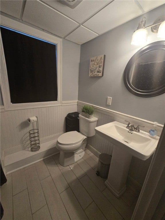 59 Columbus Ave, North Providence, RI 02911 - half bathroom featuring toilet, wainscoting, and wood finished floors
