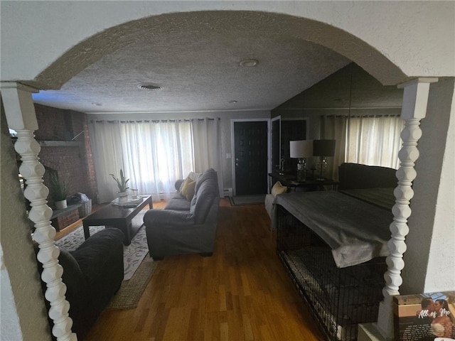 59 Columbus Ave, North Providence, RI 02911 - living room featuring wood finished floors, arched walkways, healthy amount of natural light, and a textured ceiling